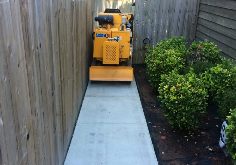 A walkway with a yellow cart in the middle of it.